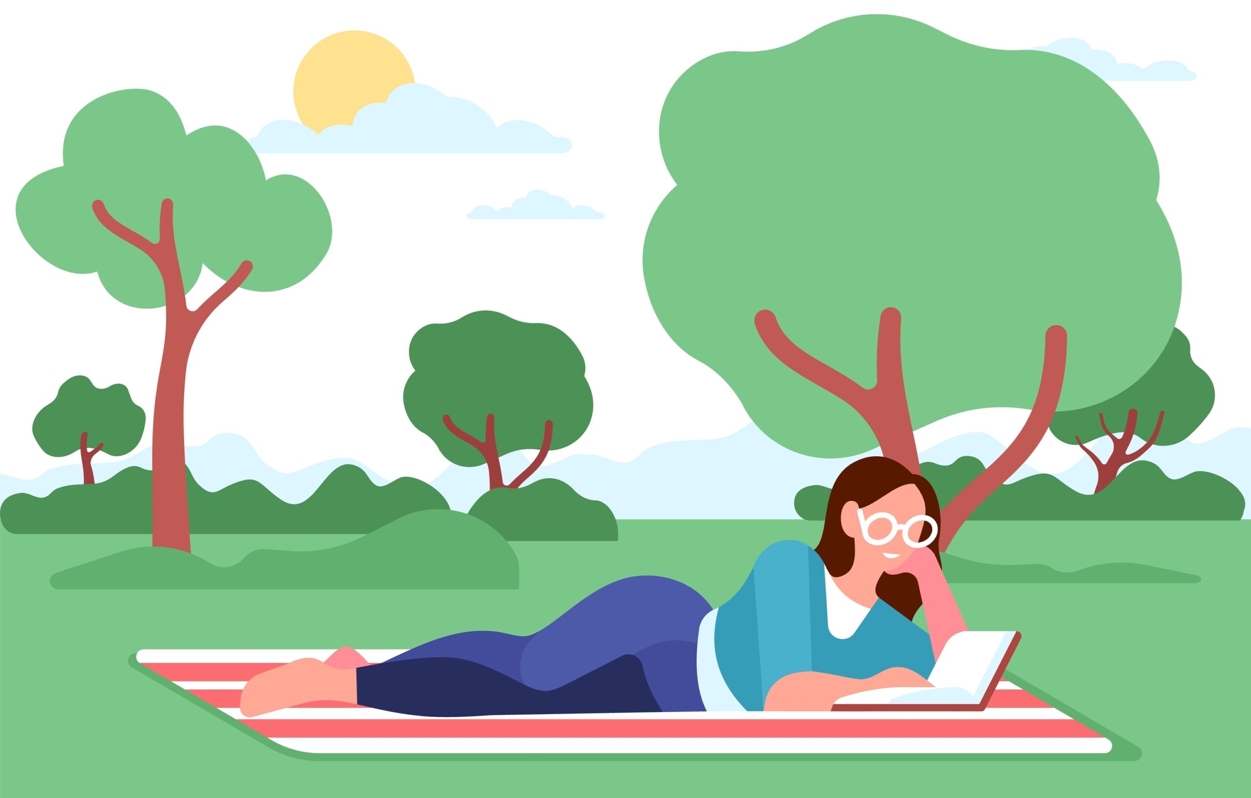 A woman sits on a picnic blanket while reading a book outside. It is a sunny summer day.